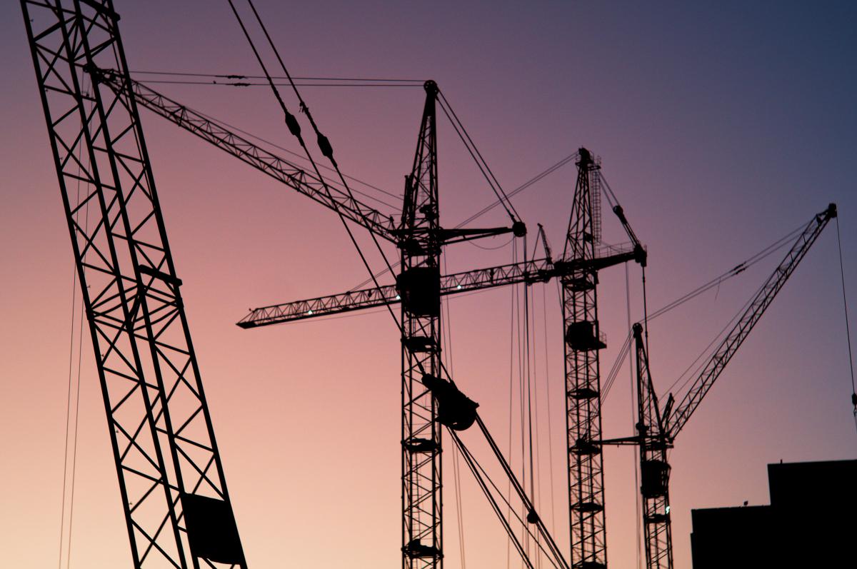 Cranes on construction sight at dusk